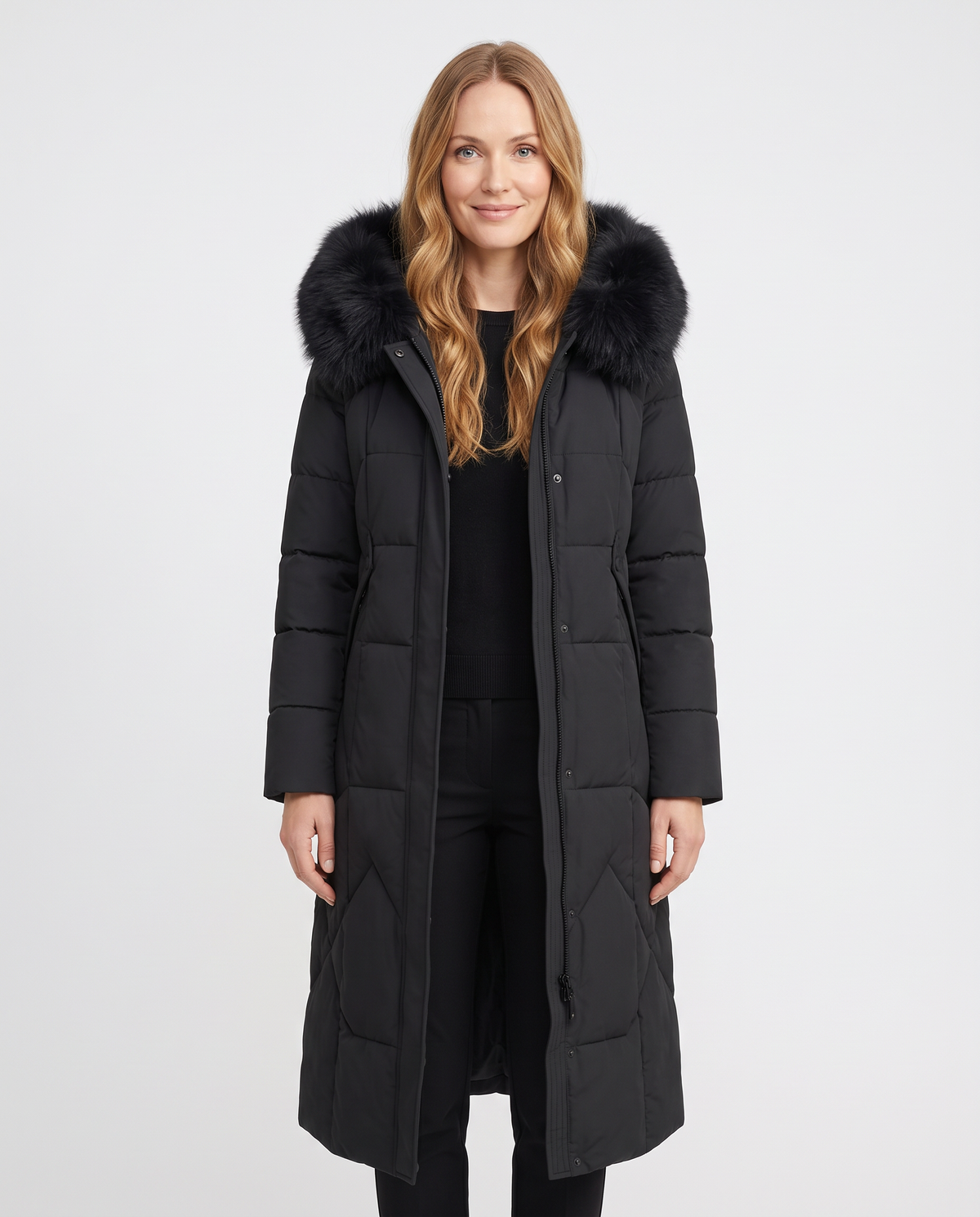 Women's black long quilted puffer coat with faux fur collar, front view
