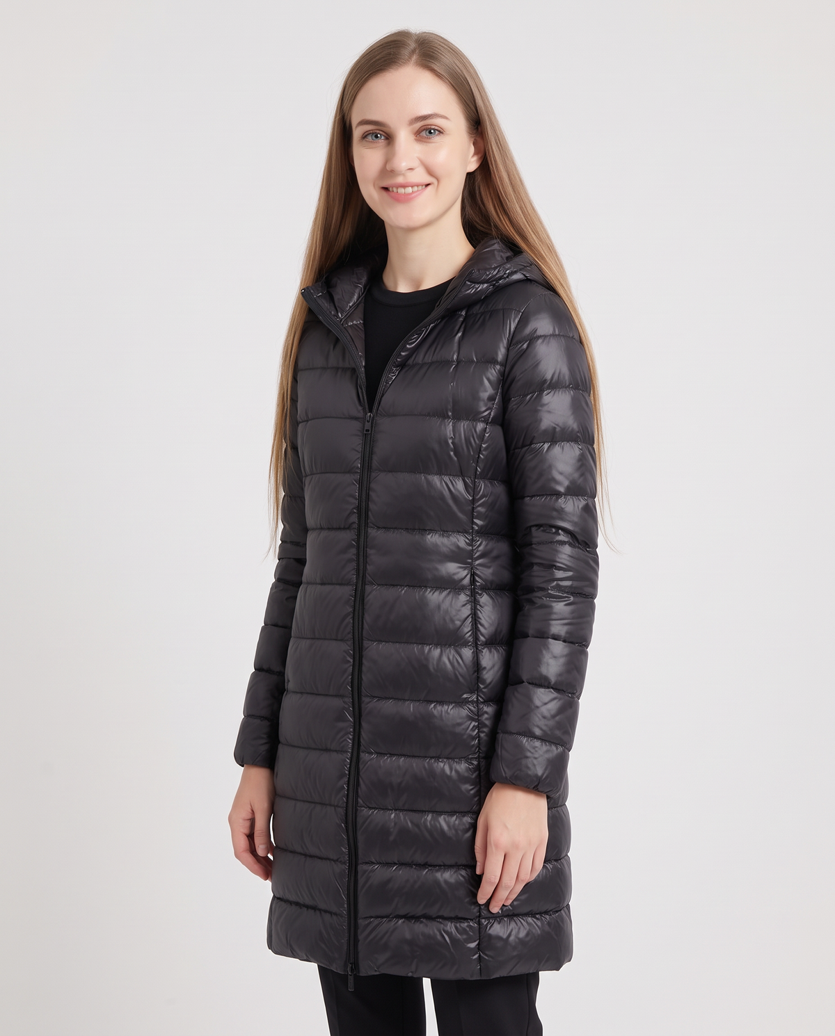 Women's black longline hooded puffer coat, side view