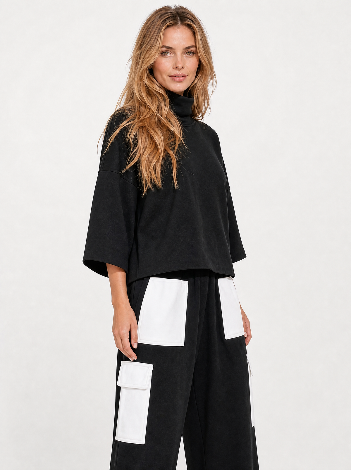 Women's black oversized sweatshirt and cargo jogger tracksuit, side view