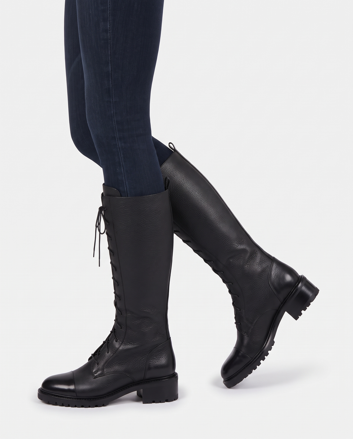 Women's Lace-Up Knee-High Boots in Black – side profile walking view