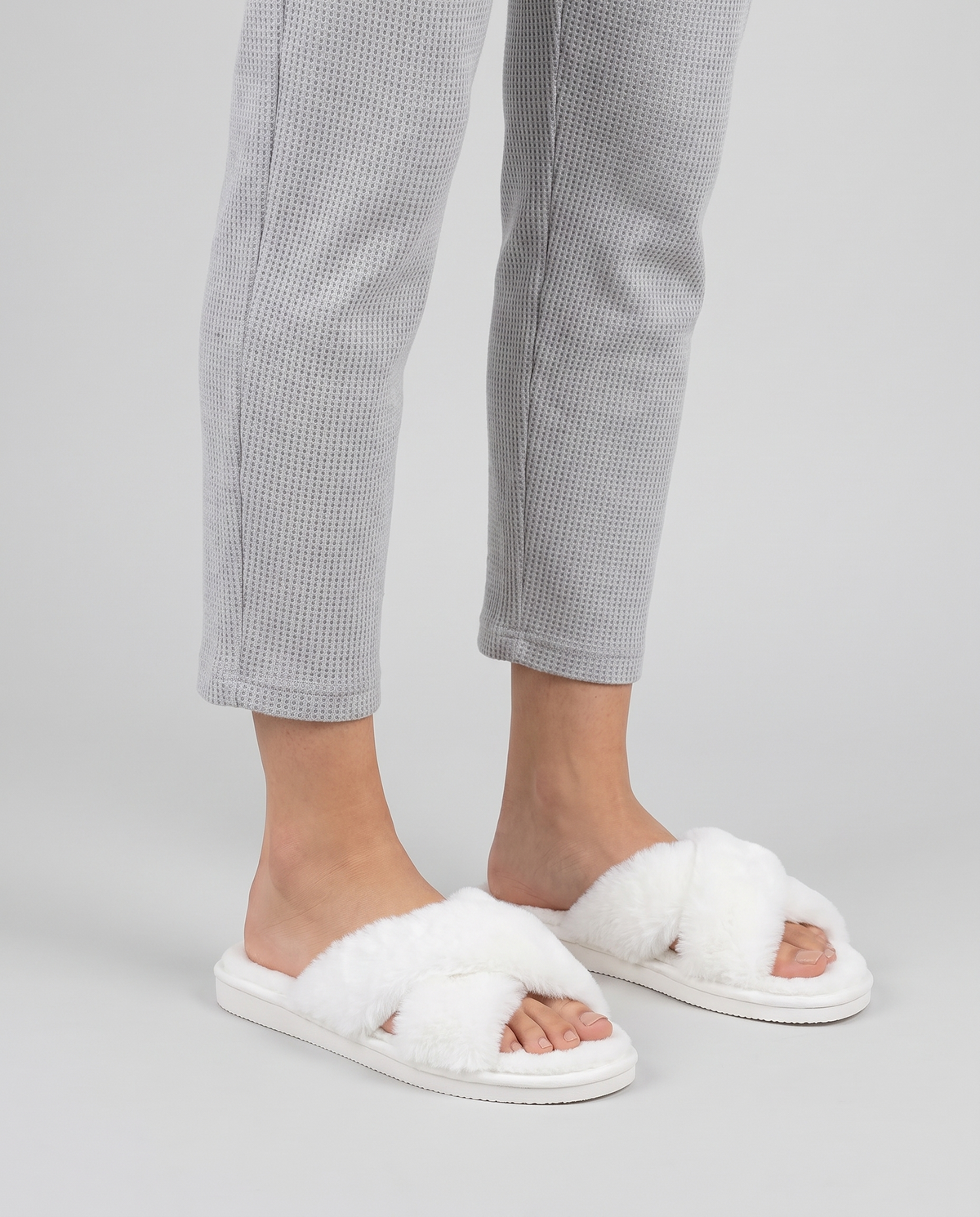 Women's Plush Cross-Strap Slippers in White – three-quarter standing view