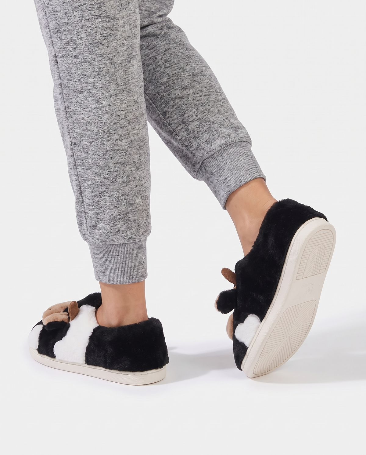 Women's Printed Plush House Slippers in Black – walking view showing the sole